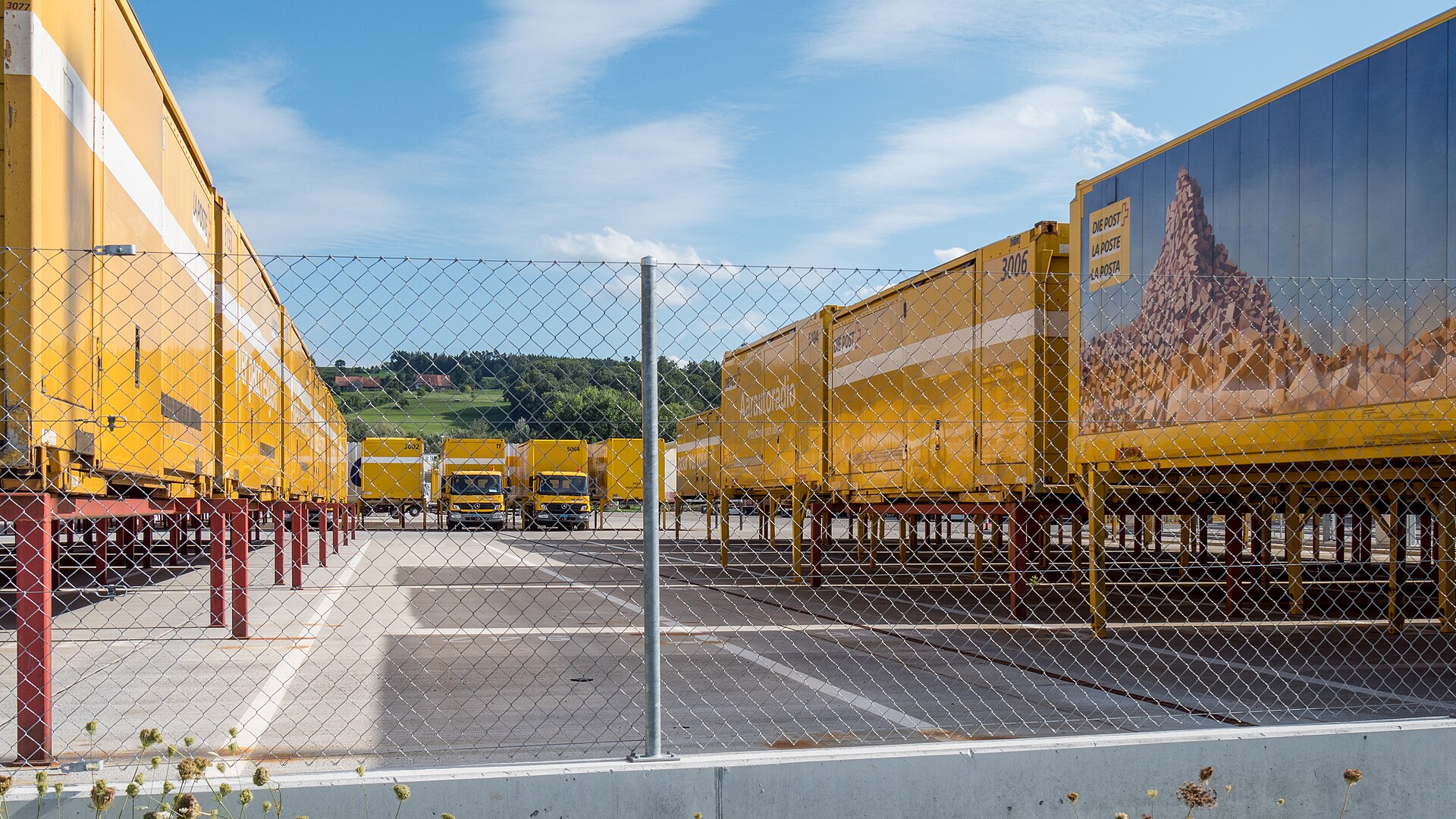 Paketverteilzentrum in Frauenfeld: Parkplatz mit Fahrzeugen, Wechselbrücken und Containern.